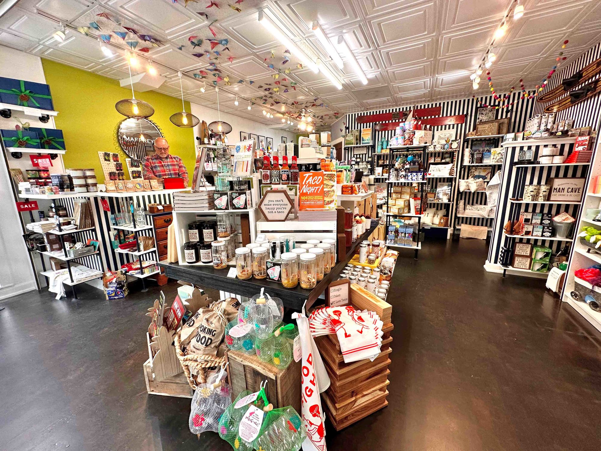 black and white striped walls with various items on shelves